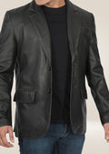 Close-up of the men's black two-button leather blazer, showcasing the smooth leather texture and contemporary design.