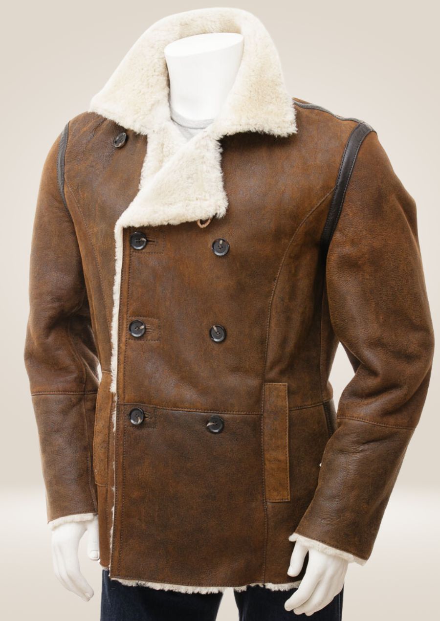 Tan sheepskin shearling pea coat with a double-breasted front, offering luxurious winter warmth and style